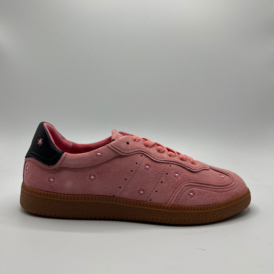 Right facing view of a pink suede sneaker with a black collar and a tan rubber outsole.