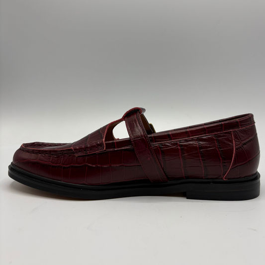 A single dark burgundy crocodile-embossed leather loafer Mary Jane shoe with a black sole, shown in a side profile against a neutral gray background.