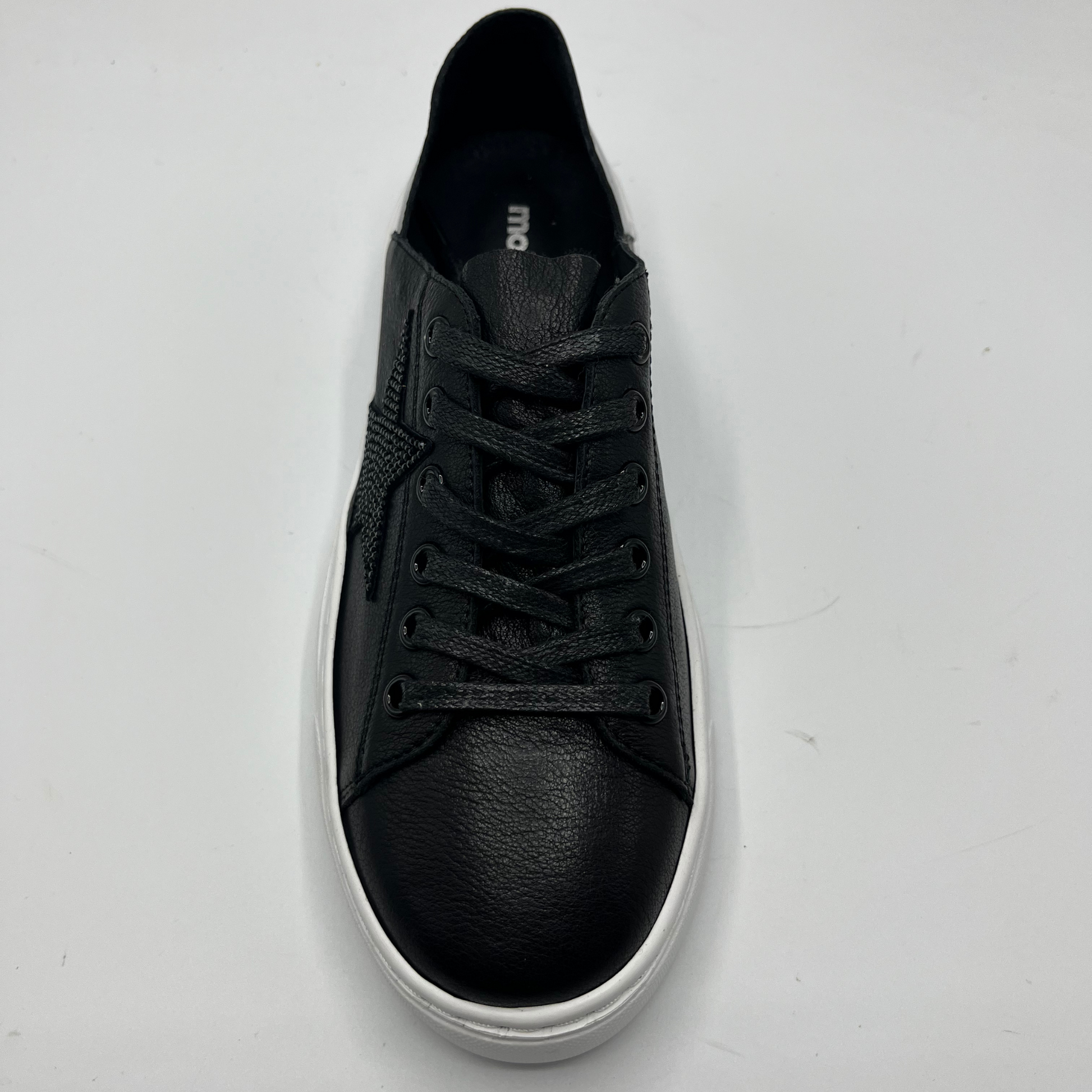 Top view of a black leather sneaker with a black bejewelled star