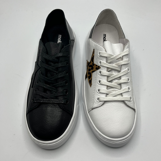 Top view of a black sneaker and a white leather sneaker
