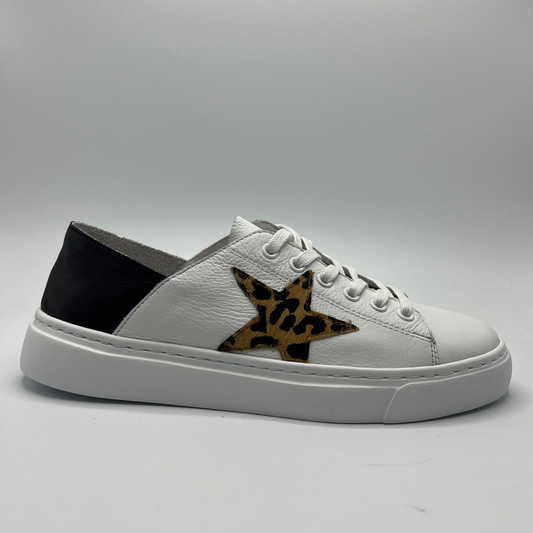 Right facing view of a white leather sneaker with a leopard print star accent.