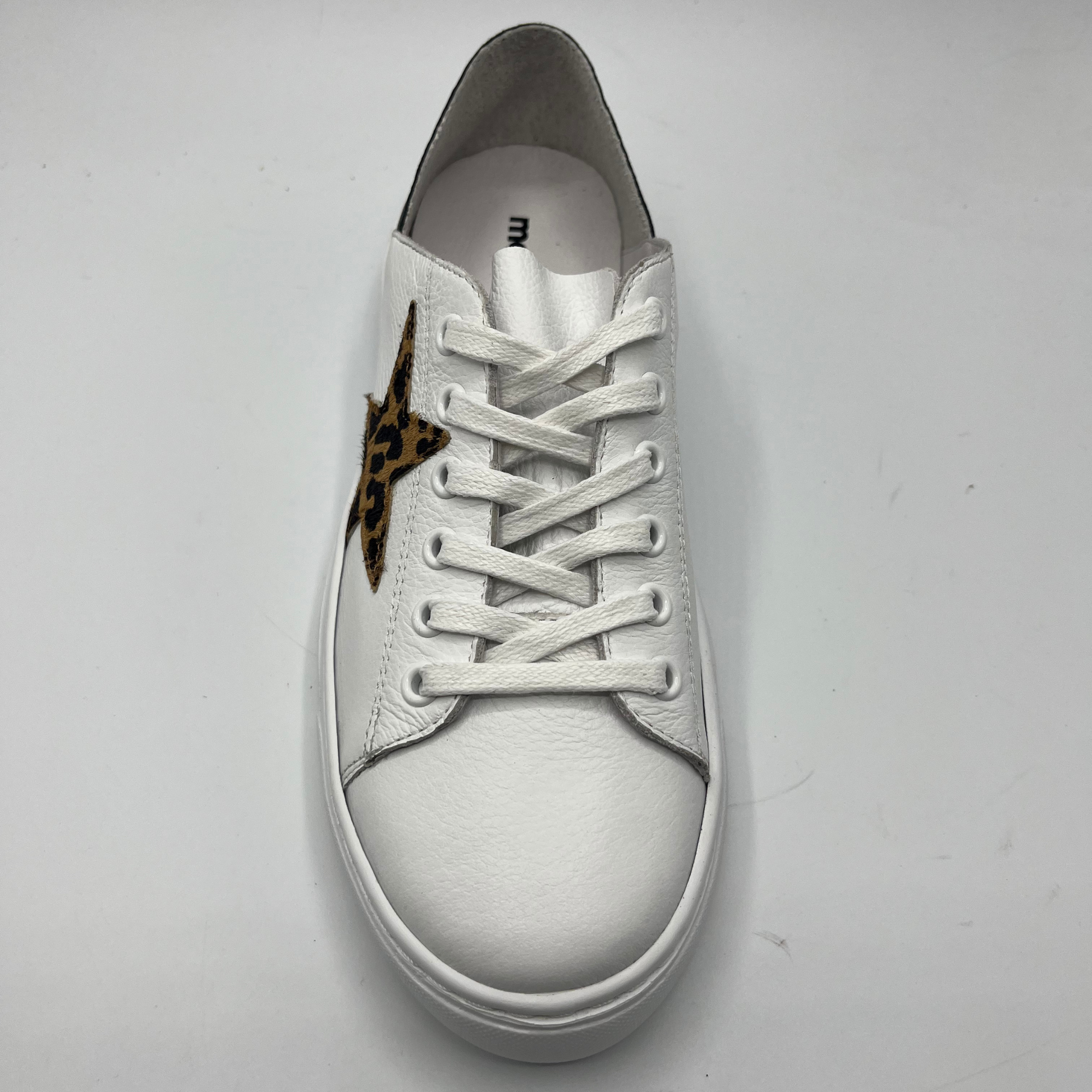 Top view of a white leather sneaker with a white rubber outsole and a leopard print star.