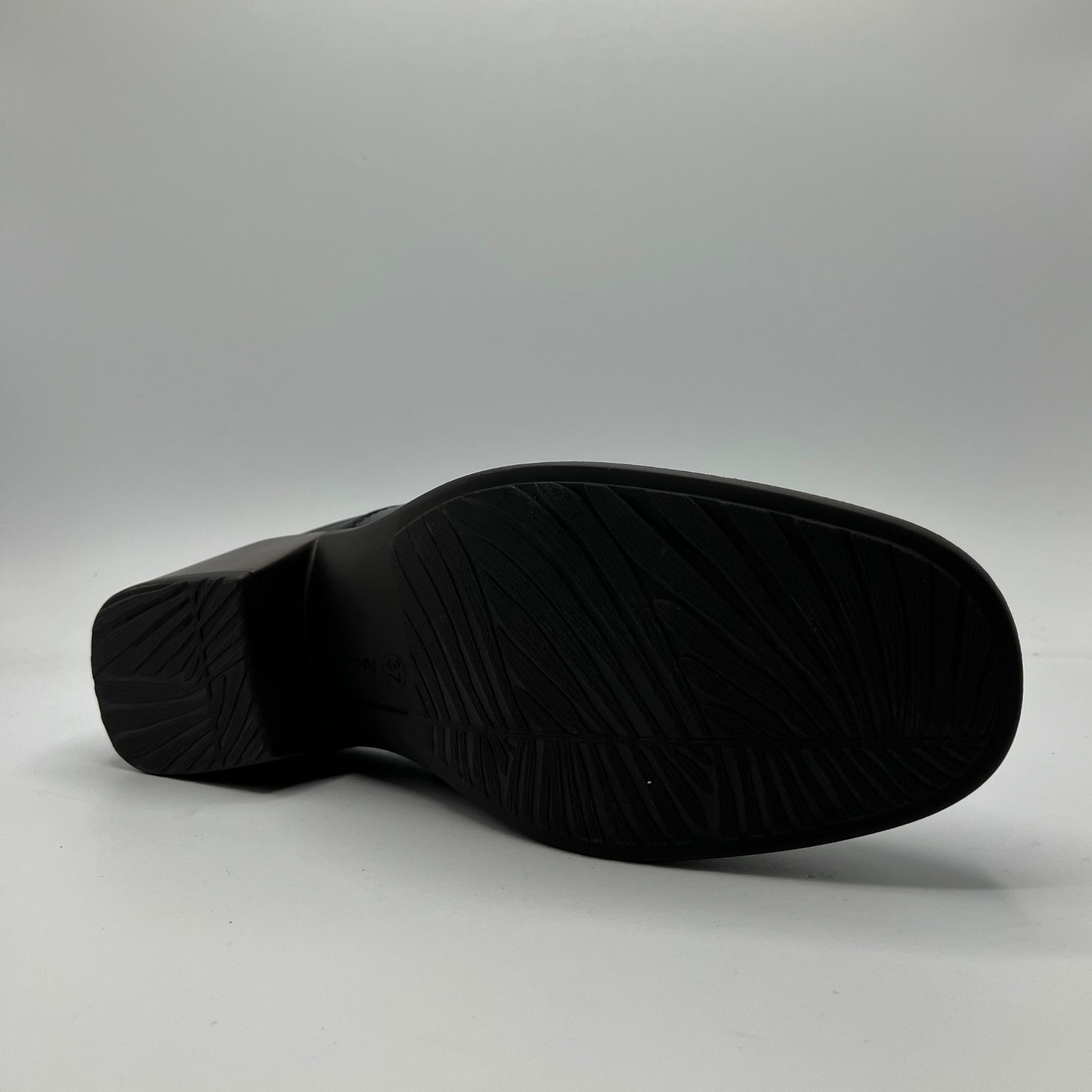 Black shoe sole on a gray background