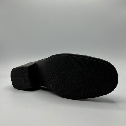 Black shoe sole on a gray background