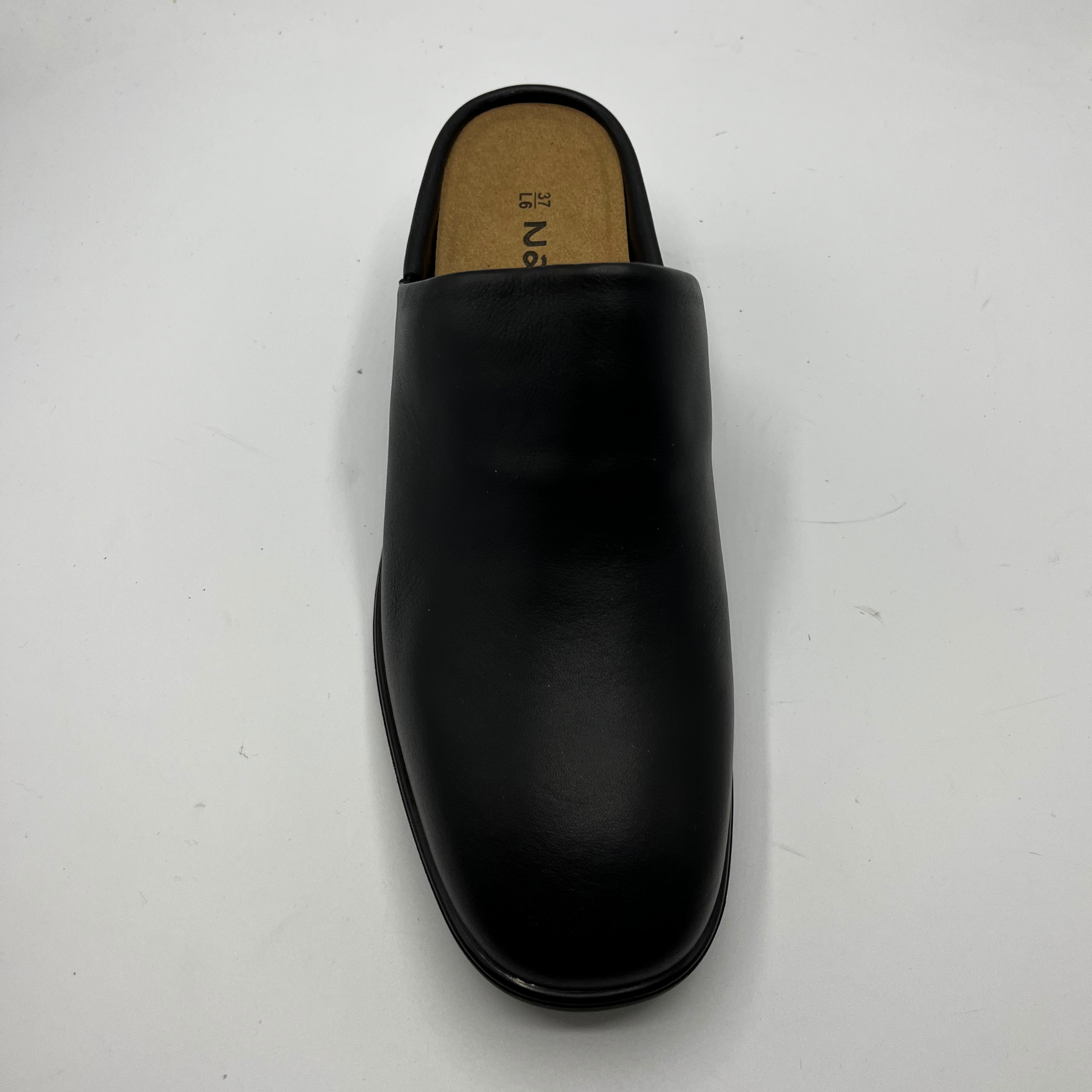 Black leather slipper on a white background