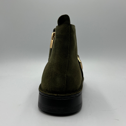 Green suede ankle boot with gold zipper on a gray background