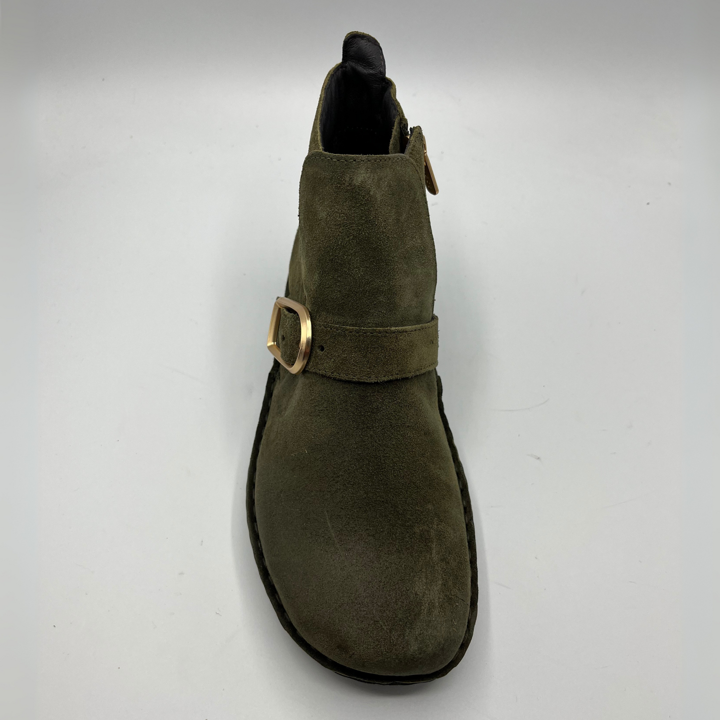 Green suede boot with a gold buckle on a white background
