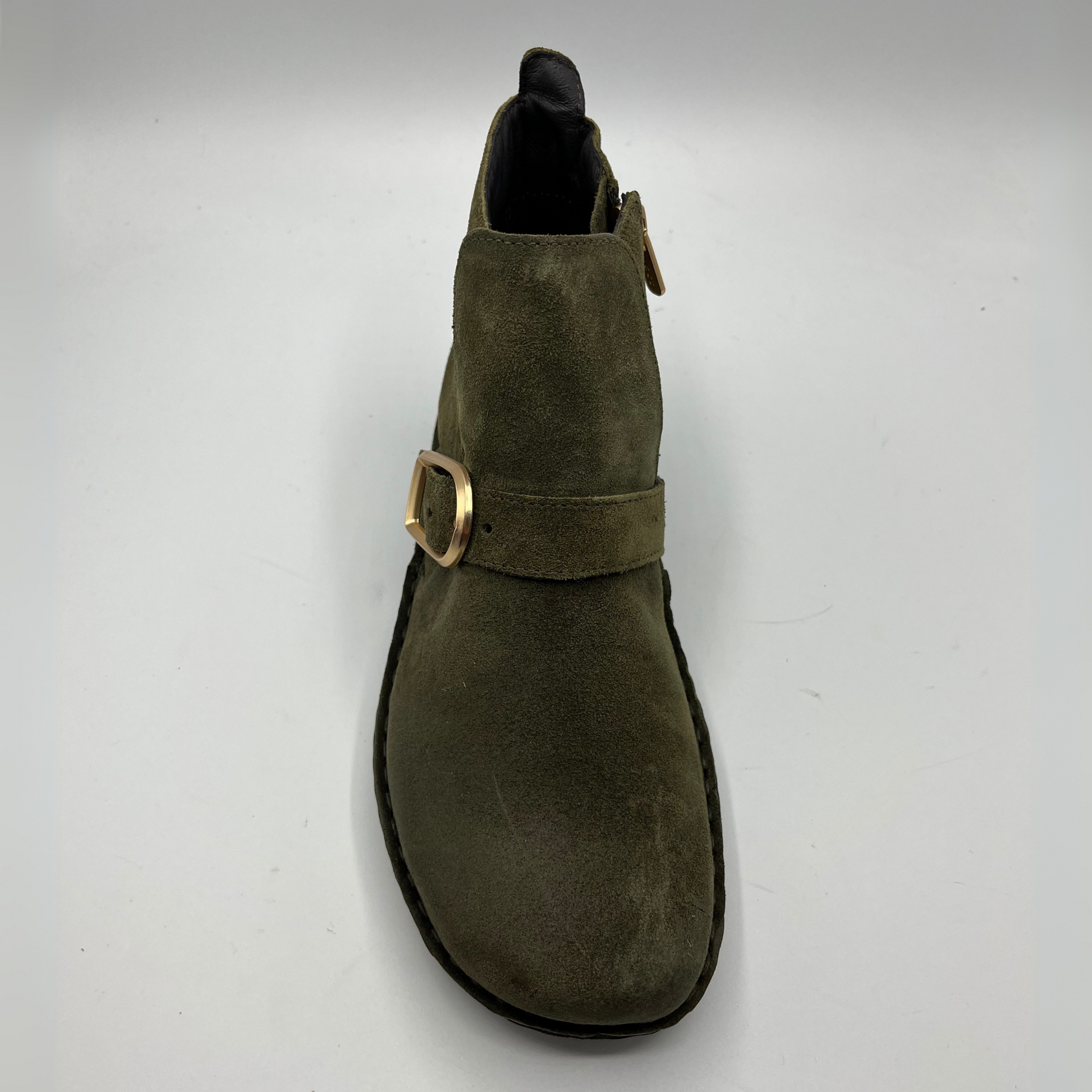 Green suede boot with a gold buckle on a white background
