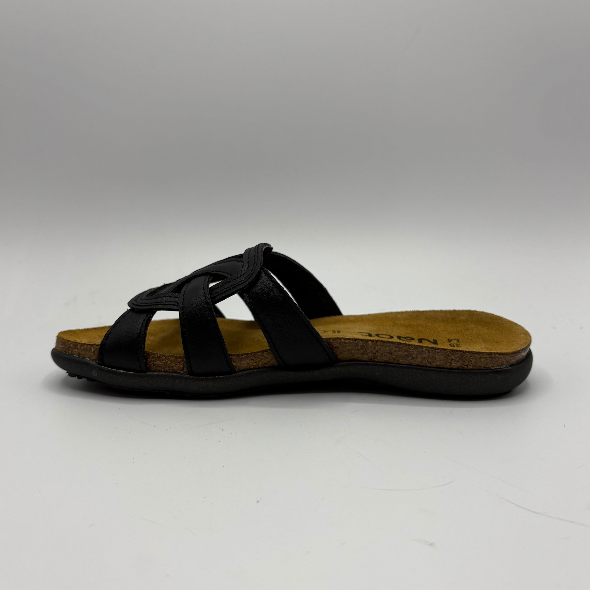 Black sandal with a cork insole on a white background