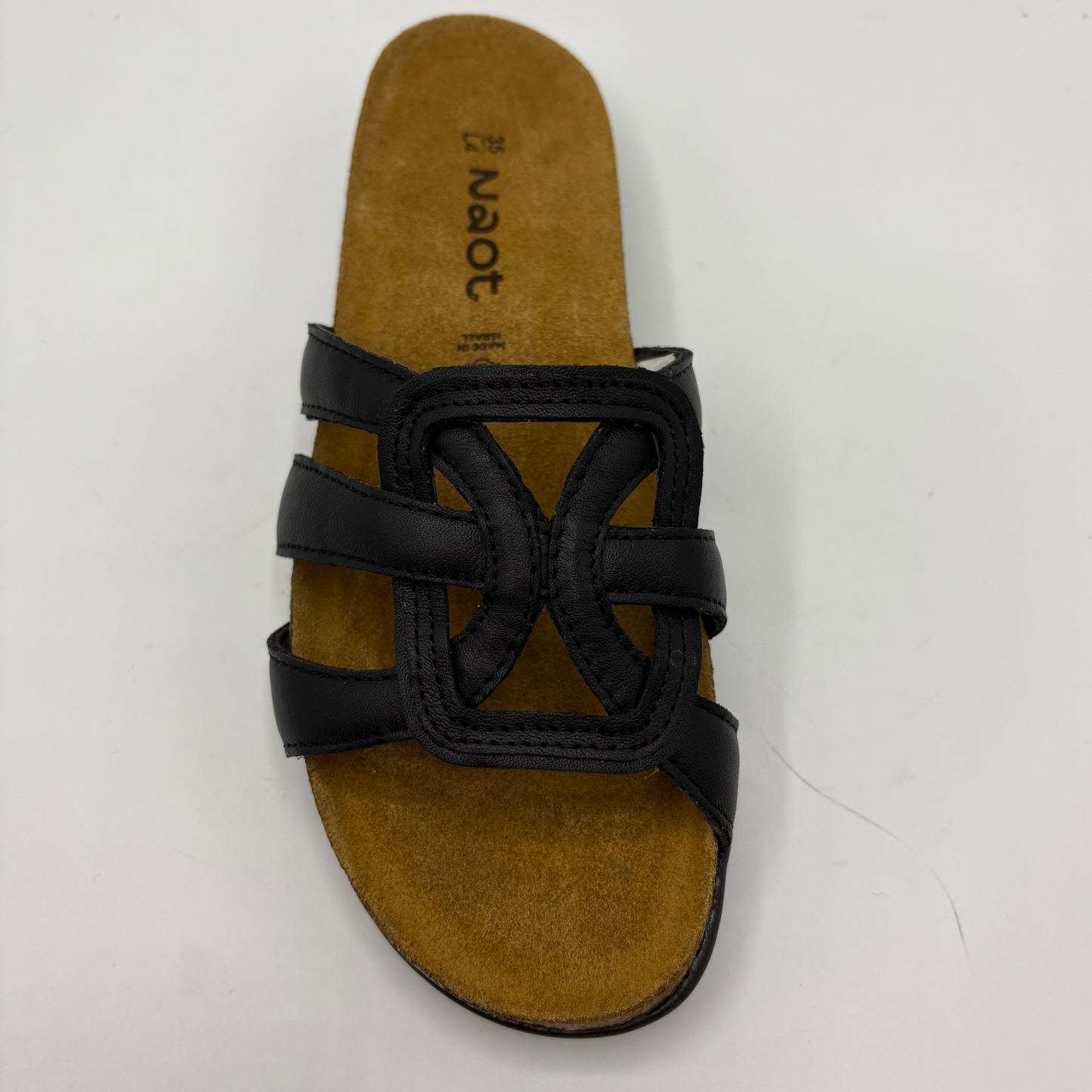 Black sandal with brown sole on a white background