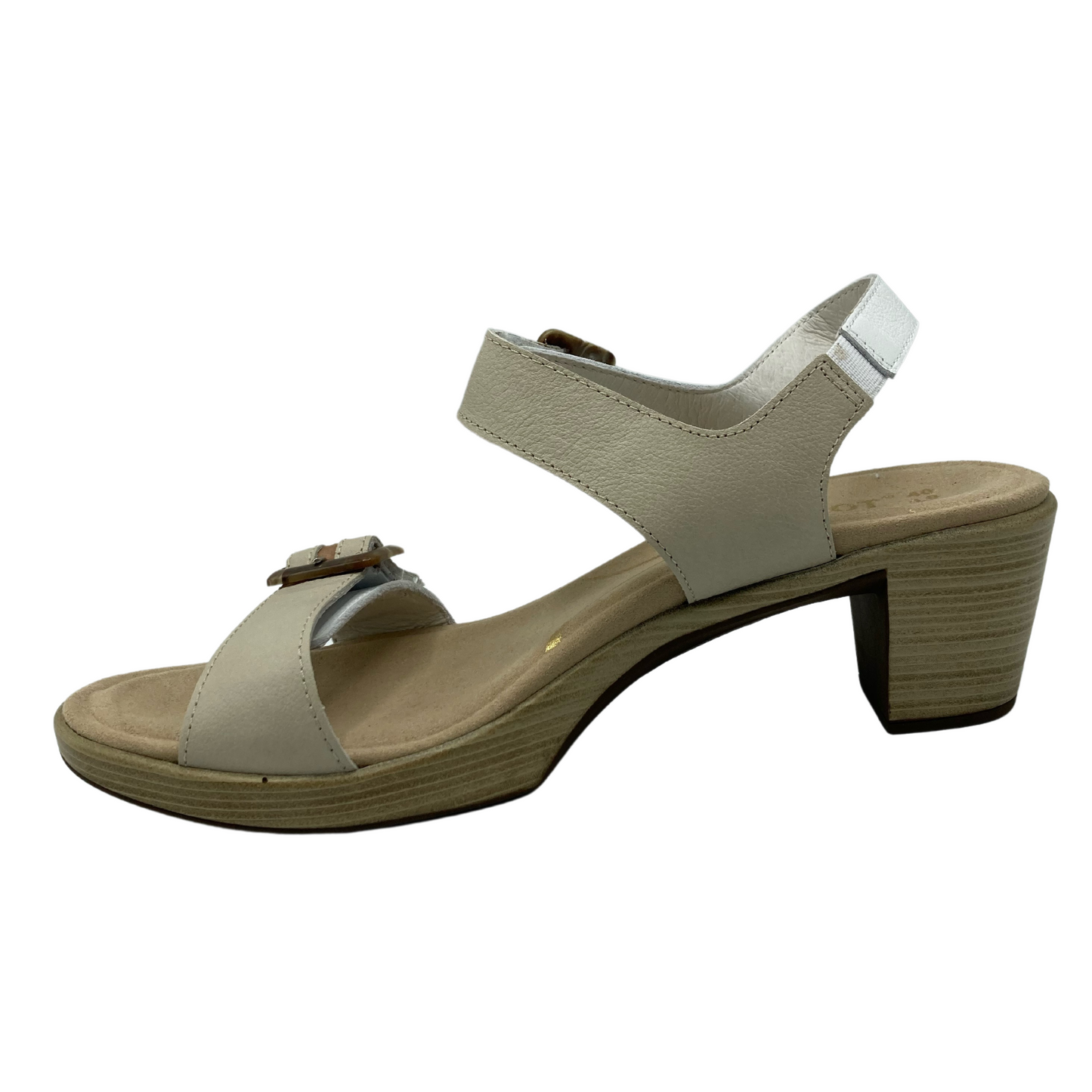Left facing view of tan and white sandal with chunky heel and buckle straps
