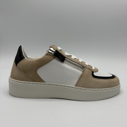Right facing view of an almond, black and white sneaker with laces and a side zipper