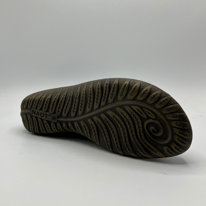 Close-up of a brown sole with tread pattern on a white background