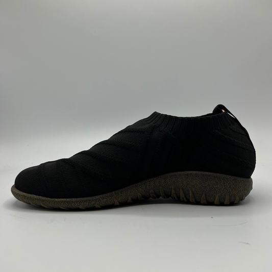 Black slip-on shoe on a gray background
