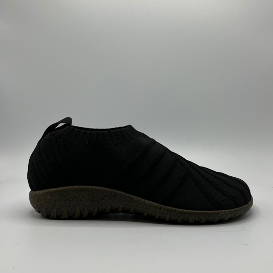 Black slip-on shoe on a gray background