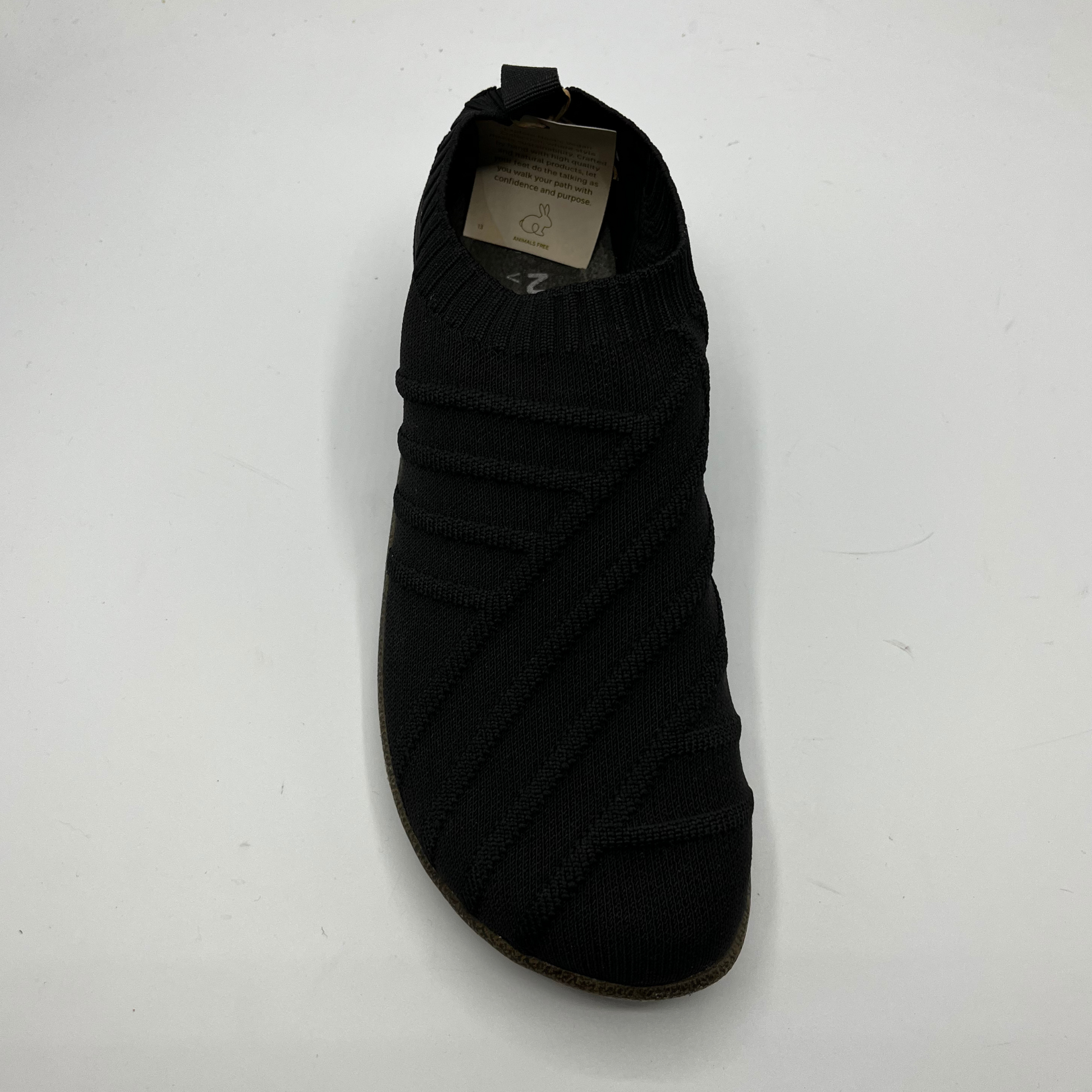 Black shoe with a brand label on a white background