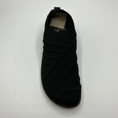 Black shoe with a brand label on a white background