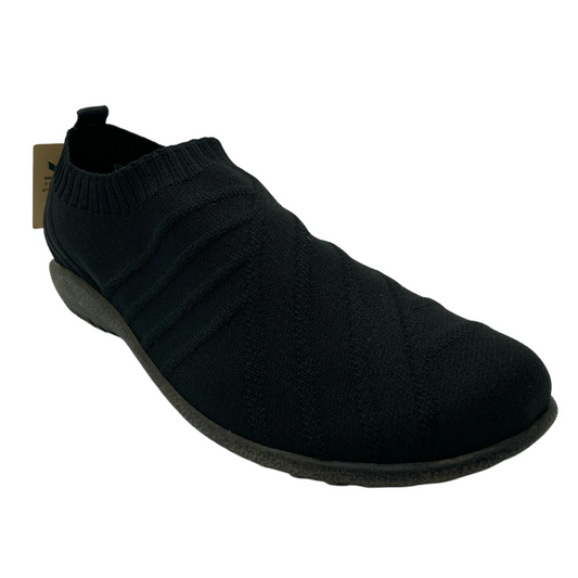 45 degree angled view of slip on sneaker with pull on tab on heel