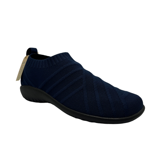 45 degree angled view of knit slip-on sneaker with sock like opening, pull on tab and slim black outsole