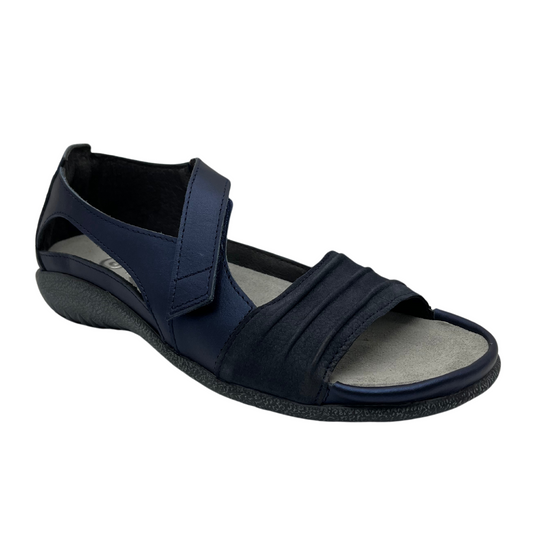 45 degree angled view of navy leather sandal with cross over velcro strap and open toe