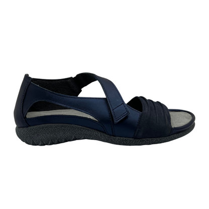 Right facing view of navy leather sandal with cross over velcro strap and open toe