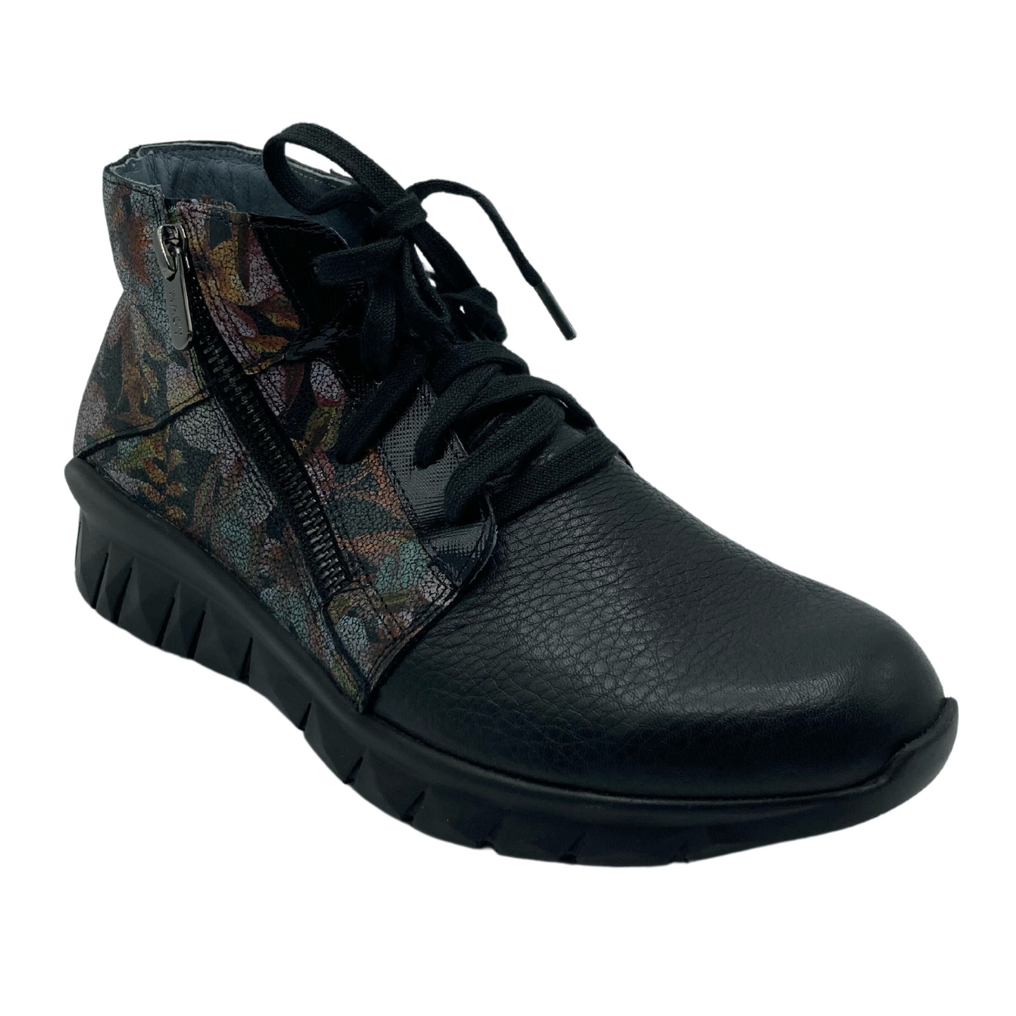 45 degree angled view of black and floral sneaker with black slip resistant outsole and black laces