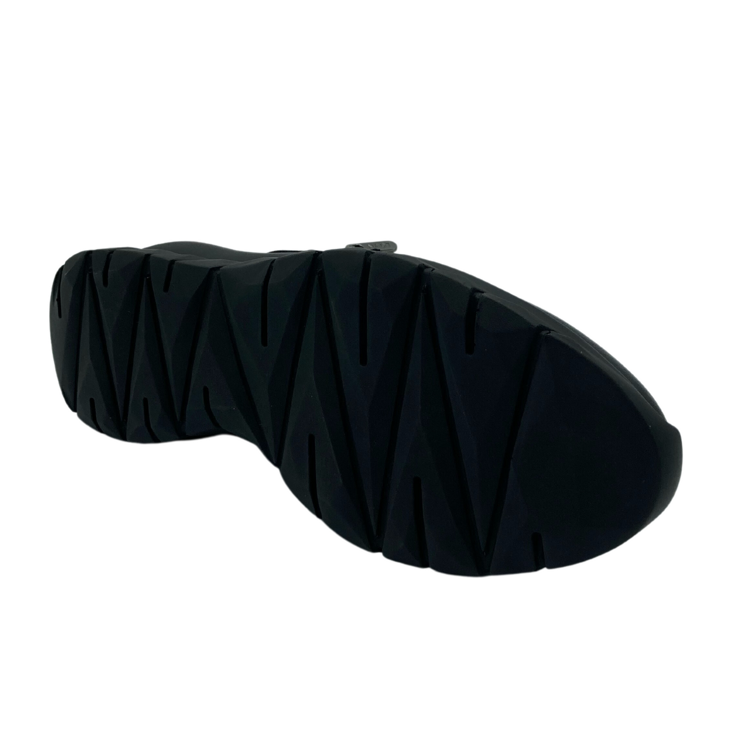 Bottom view of black leather sneaker with black slip resistant outsole