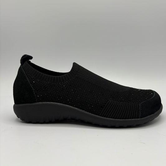 A single black knit sneaker shown in a side profile on a light gray background.