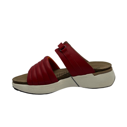 Left facing view of red leather slip on sandal with white rubber outsole, padded front strap and open toe