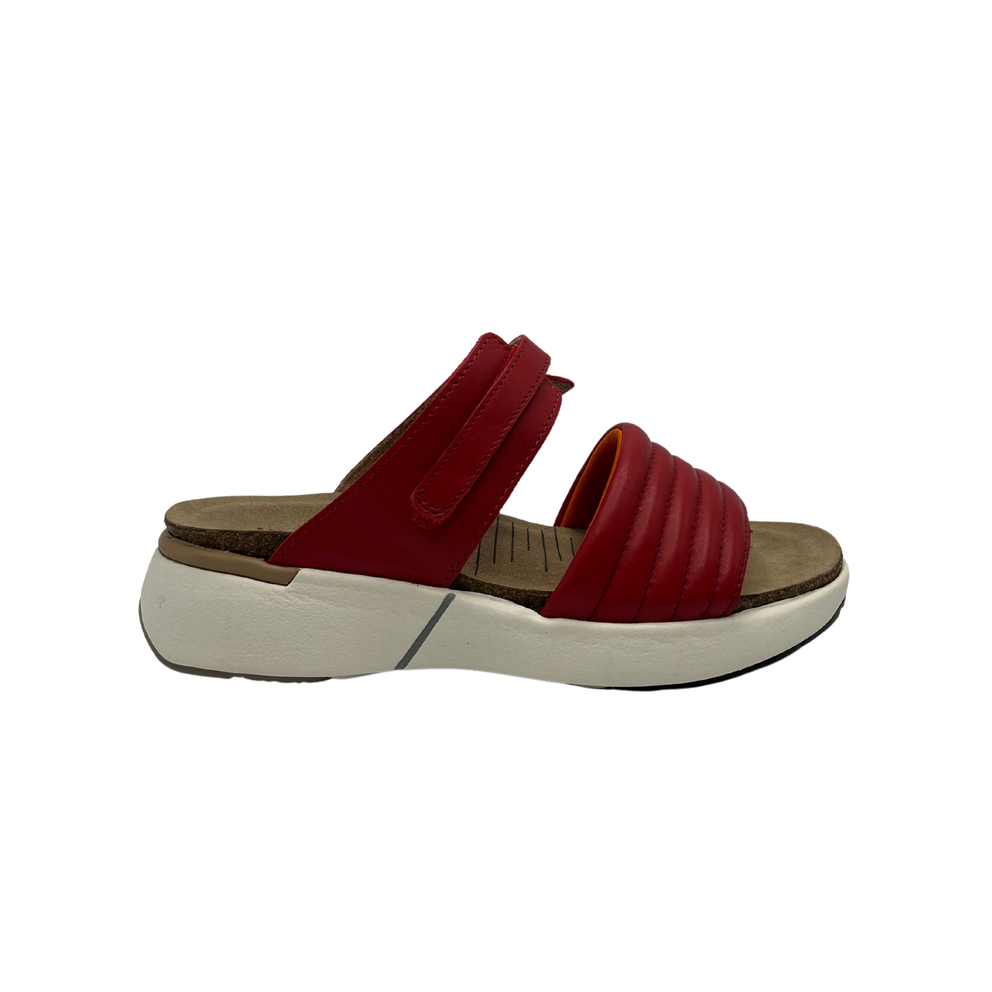 Right facing view of red leather slip on sandal with white rubber outsole, padded front strap and open toe