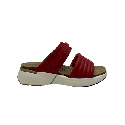 Right facing view of red leather slip on sandal with white rubber outsole, padded front strap and open toe