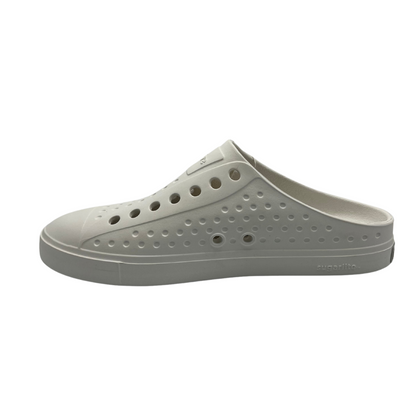 Left facing view of white slip on summer shoe. Perforated upper and rounded toe