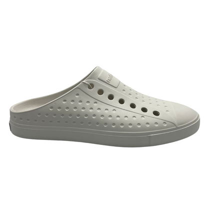 Right facing view of white slip on summer shoe. Perforated upper and rounded toe