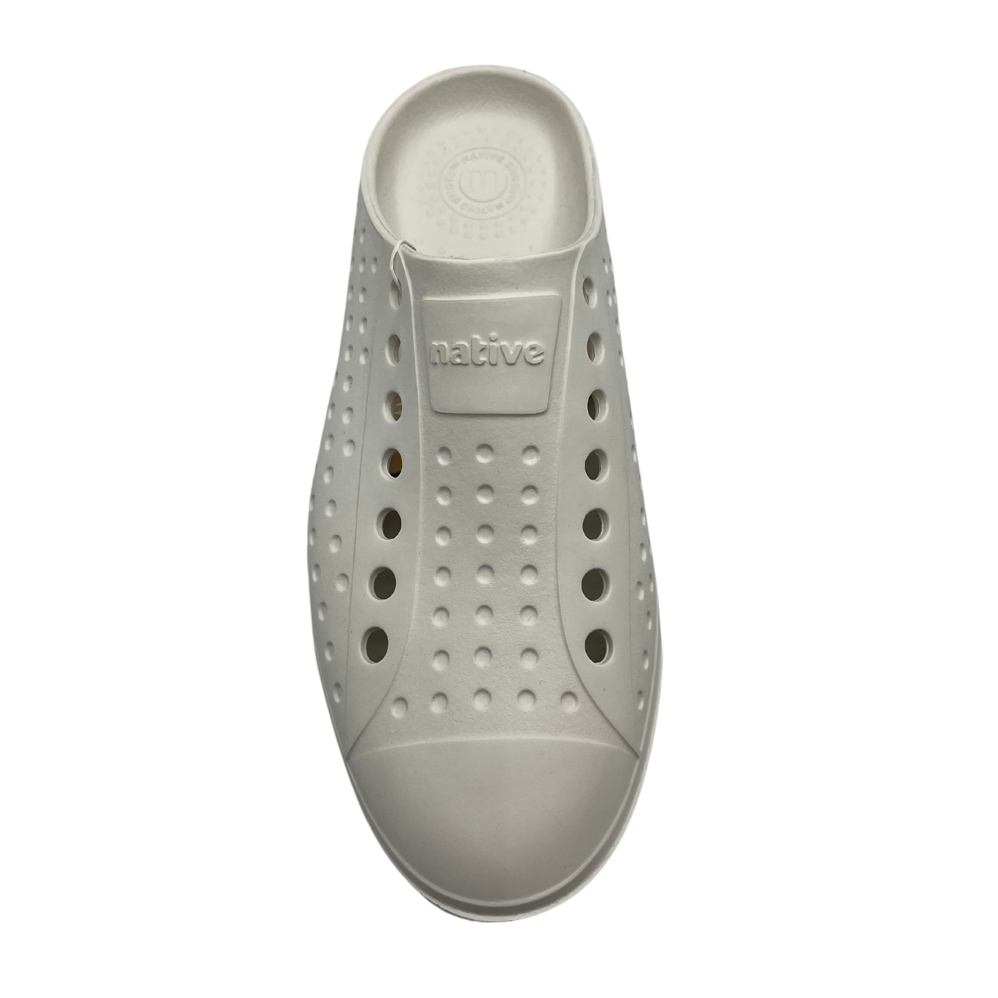 Top view of white slip on summer shoe. Perforated upper and rounded toe