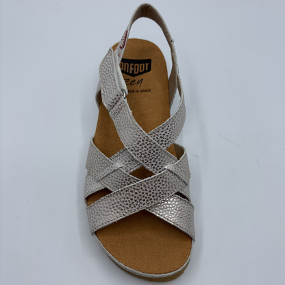 Silver sandal with criss-cross straps on a white background
