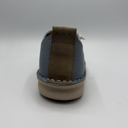Sole of a shoe with brown and blue color scheme on a gray background