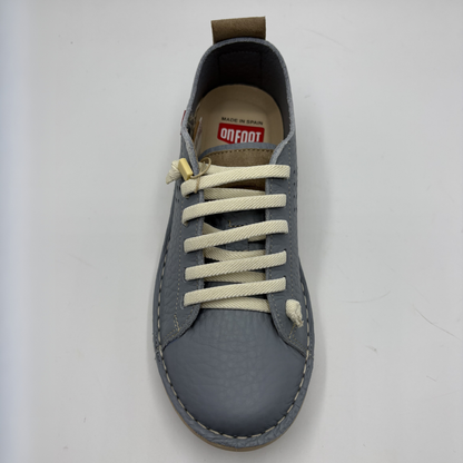 Gray sneaker with white laces on a light gray background