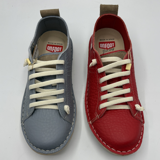 Top view of a blue shoe and a red shoe both with white laces