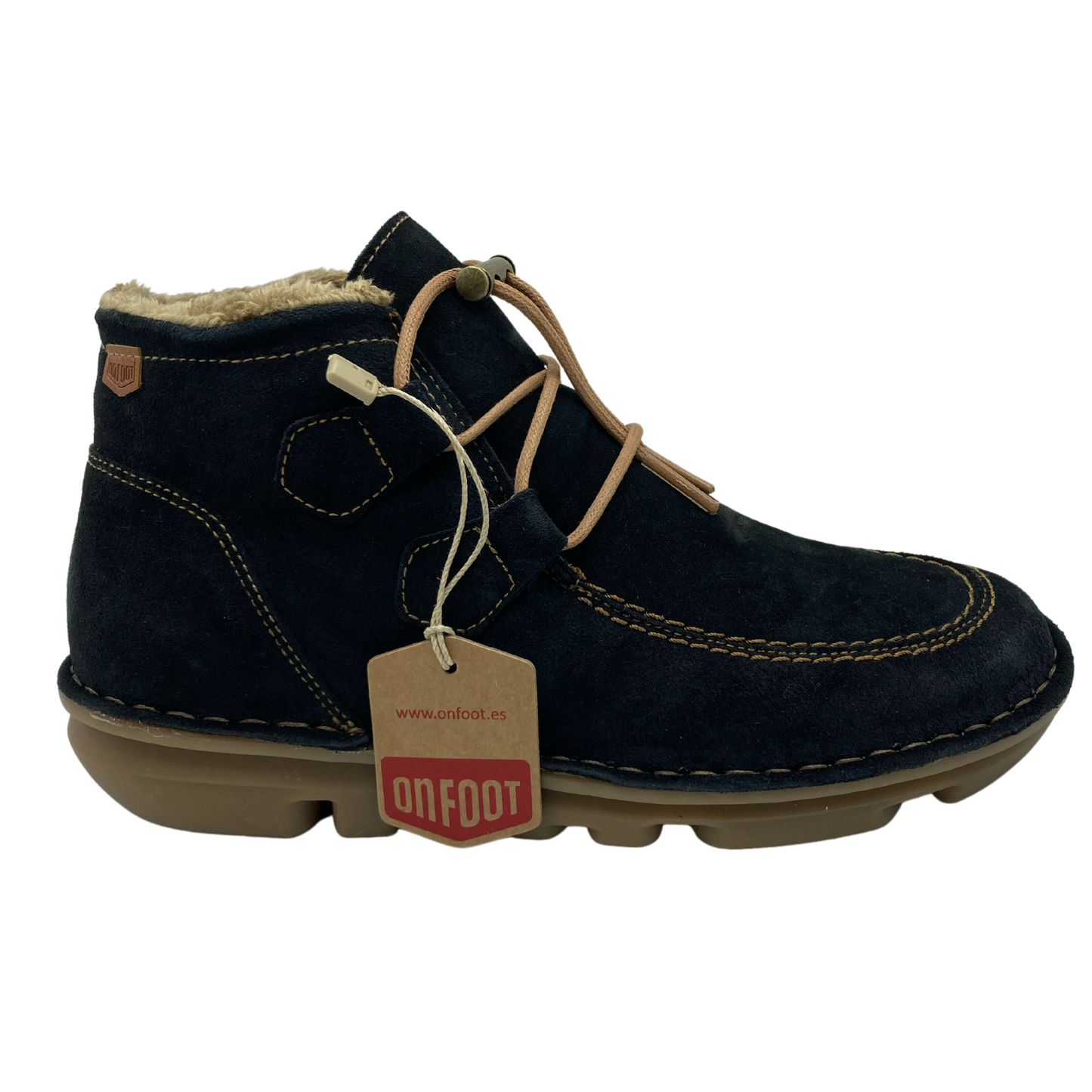 Right facing view of blue suede short boot with light brown rubber sole and tan stitching.