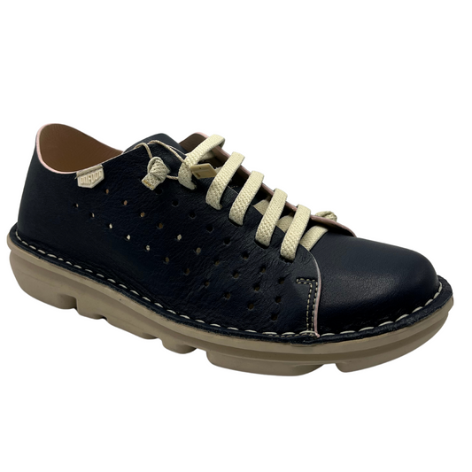 45 degree angled view of a navy perforated leather sneaker with cream laces and matching rubber outsole.