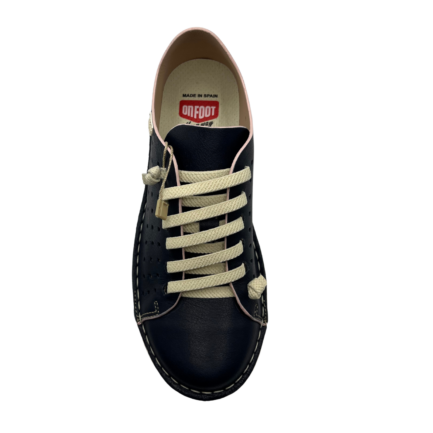 Top view of a navy perforated leather sneaker with cream laces and matching rubber outsole.