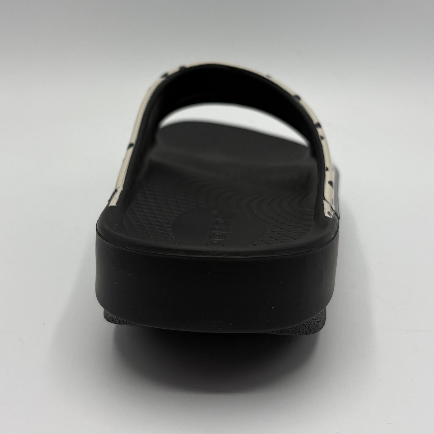 Black slide sandal on a light gray background