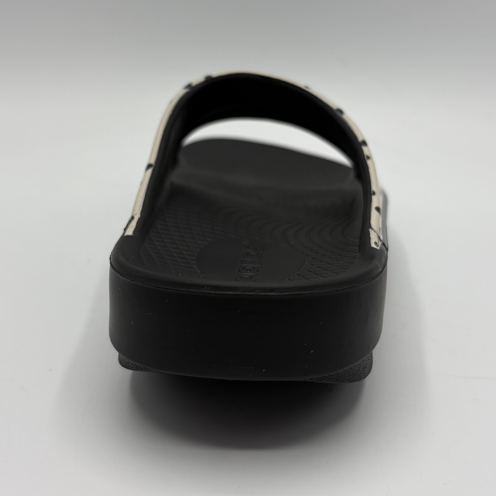 Black slide sandal on a light gray background