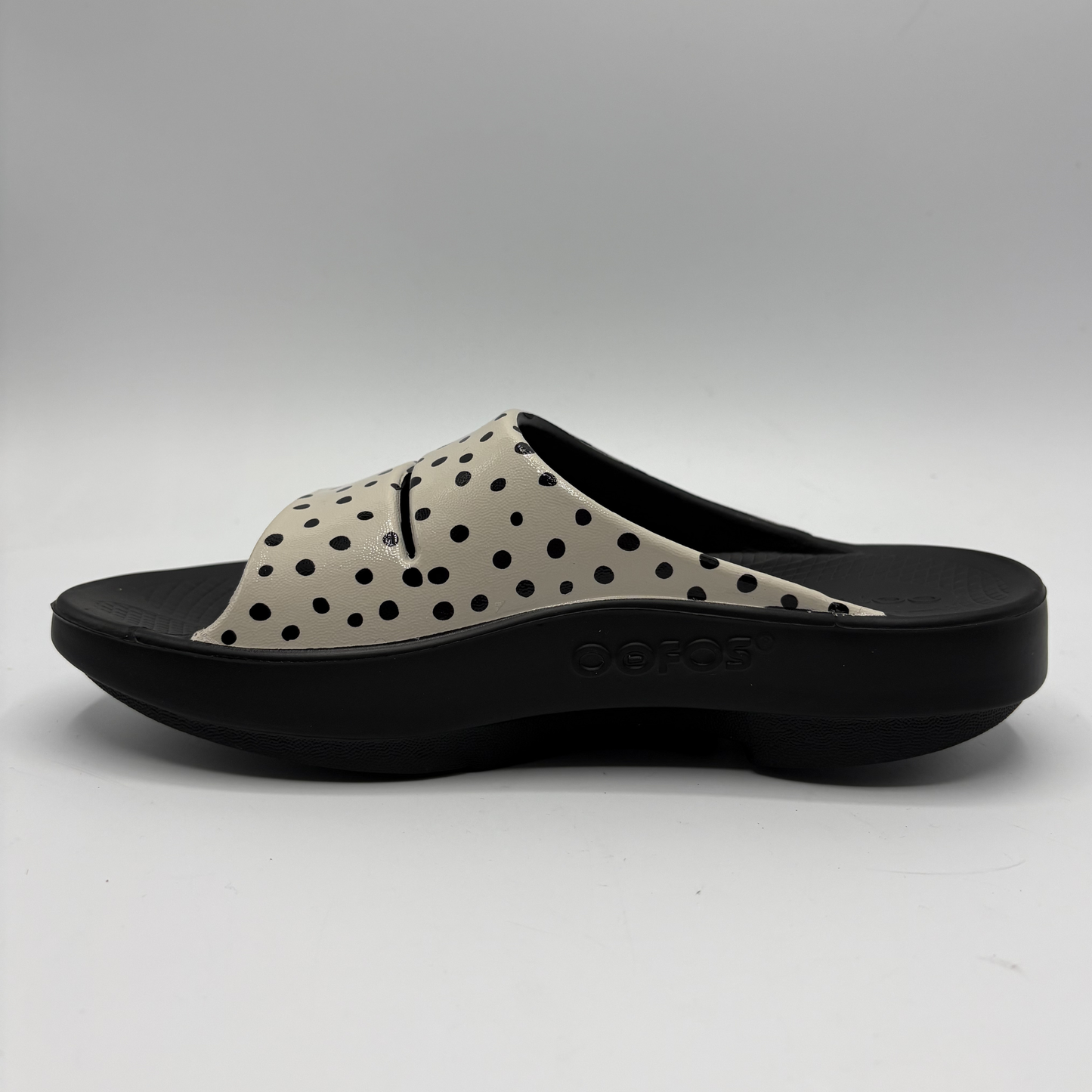 Black and beige polka dot sandal on a white background