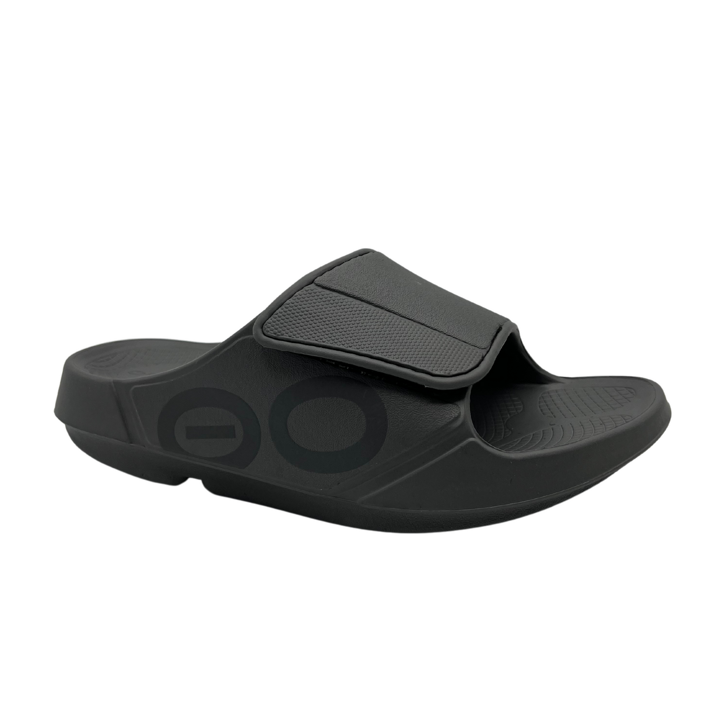 45 degree angled view of slate grey slip on sandal with foam footbed and strap with adjustable velcro