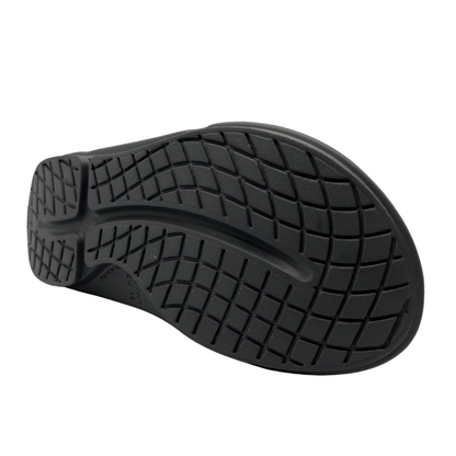 Bottom view of slate grey slip on sandal with foam footbed and strap with adjustable velcro