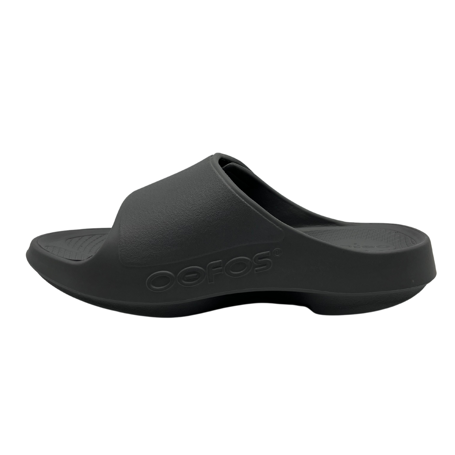 Left facing view of slate grey slip on sandal with foam footbed and strap with adjustable velcro