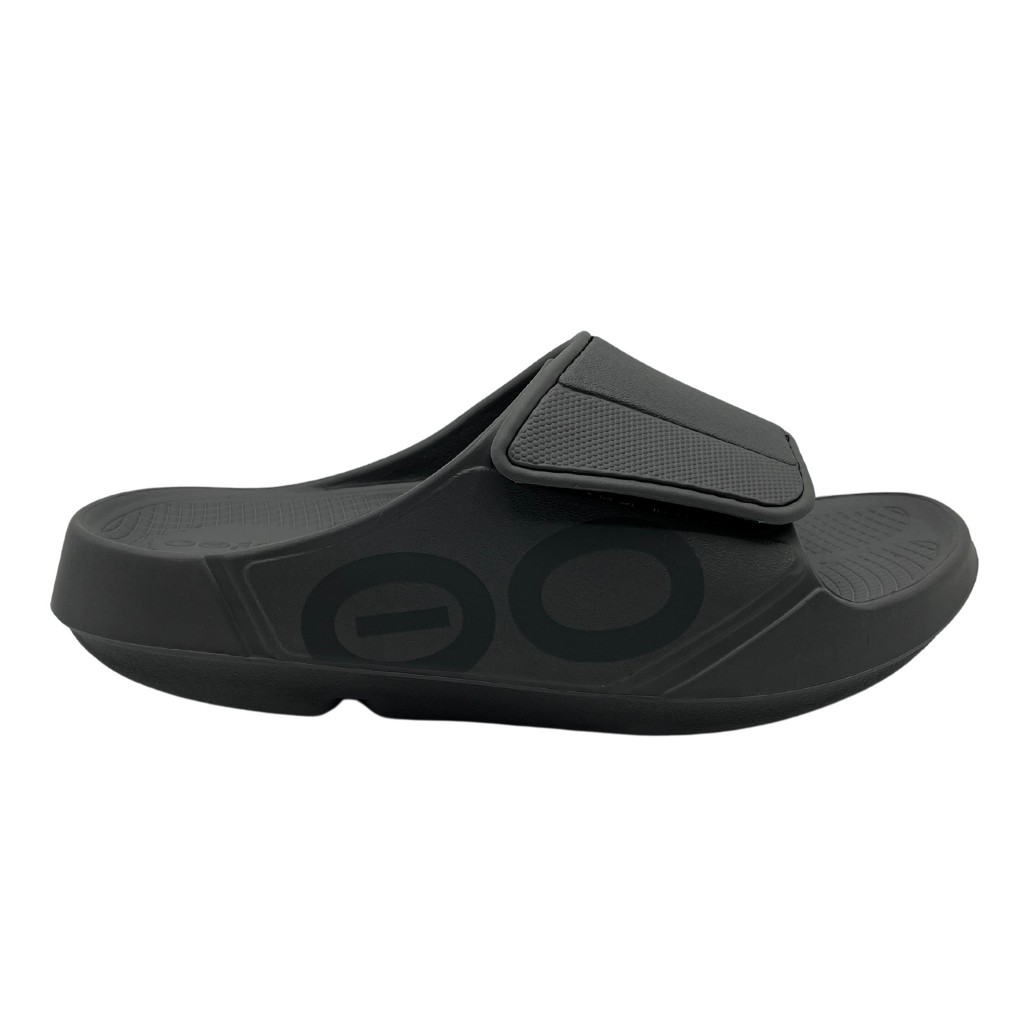 Right facing view of slate grey slip on sandal with foam footbed and strap with adjustable velcro