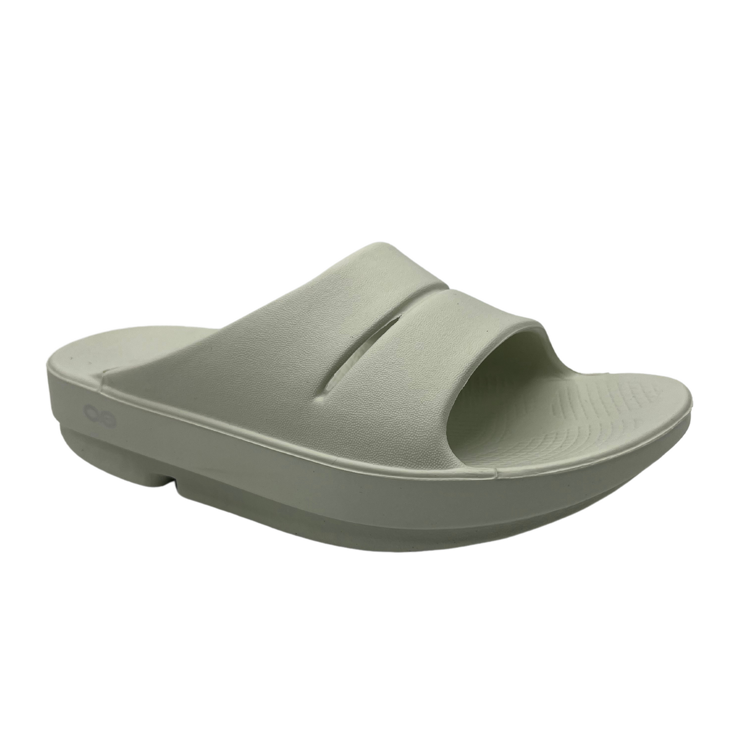 45 degree angled view of a grey foam slide with two over-foot straps and a grippy sole.