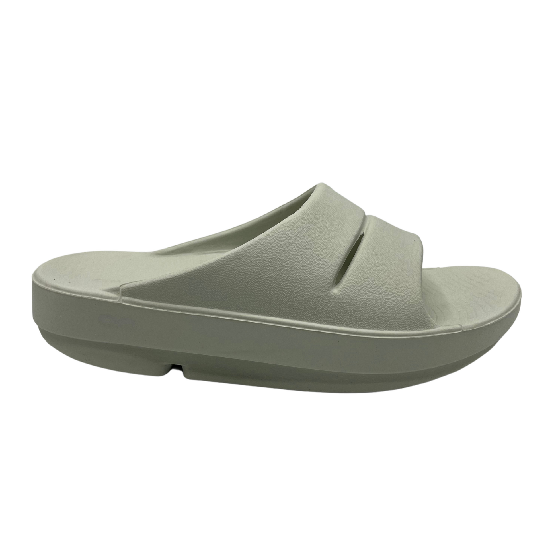 Right facing view of a grey foam slide with two over-foot straps and a grippy sole.